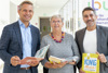 LR Dr. Wolfgang Hattmannsdorfer, Mag.a Gabriele Müller und Sefa Yetkin stehen nebeneinander im Gangbereich des OÖ. Presseclubs, sie halten Kinderbücher in den Händen.
