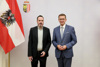 Johannes Reichl und Wirtschafts- und Energie-Landesrat Markus Achleitner stehen nebeneinander, seitlich ist eine Österreich-Fahne sichtbar