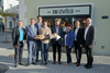 GV Ing. Mag. (FH) Albert Sprung, Wirtschafts- und Raumordnungs-Landesrat Markus Achleitner, P. Franz Ackerl, Christina und Gerhard Helmberger, Vizebürgermeisterin Margit Kriechbaum, GV LAbg. Mag. Reinhard Ammer und Bürgermeister Johann Mitterlehner stehen nebeneinander vor einem Haus mit der Aufschrift „IM GWÖLB seit 2023“; einige von ihnen halten einen Korb mit Gebäck in ihren Händen. 