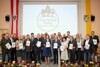 Gruppenfoto, 25 Personen in zwei Reihen vor einer Videowand mit Beschriftung Forst & Dialog, Mariazeller Erklärung, Illustration eines Baumes, eines Pfotenabdrucks und eines Hufabdrucks