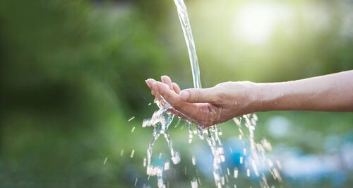 Hand unter einem Wasserstrahl