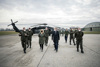 Bundesministerin Mag.a Klaudia Tanner und Landeshauptmann Mag. Thomas Stelzer mit Brigadier Wolfgang Wagner und Oberst Georg Klecatsky sowie weiteren Angehörigen des Bundesheeres auf einem Flugplatzgelände, im Hintergrund ein Militär-Hubschrauber