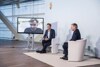 Willi Ruttensteiner, zu sehen auf einem Bildschirm, Florian Danner und Landeshauptmann Mag. Thomas Stelzer sitzend bei der Talkrunde