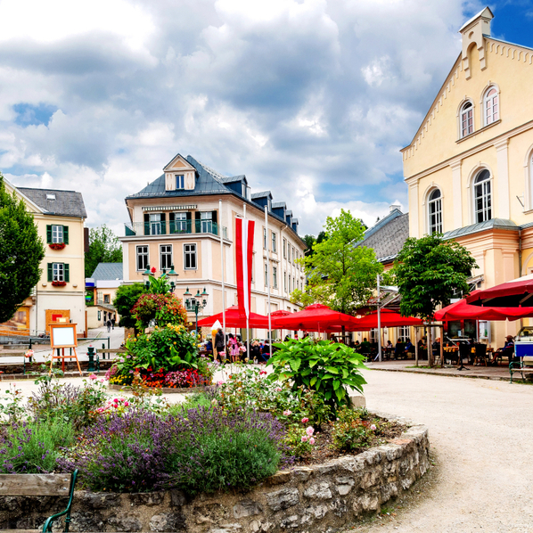 Ortsplatz mit durchlässigem Bodenbelag und üppig begrünter Insel