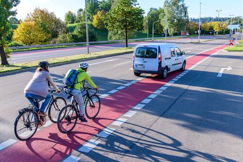 Straßenverkehrssituation mit Radfahrer und Auto